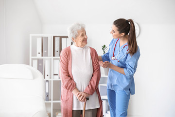 Poster - Medical worker with senior woman in nursing home