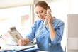 © Pixel-Shot - Young medical assistant talking by phone in clinic