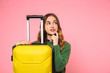 © Drobot Dean - Pensive blonde woman wearing in green sweater posing with baggage