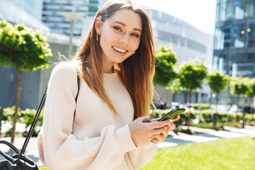 Poster - Beautiful young cheerful girl walking outdoors