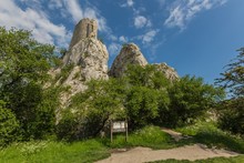 Klentnice, Czech Republic - May 26 2019: Castle Sirotci hradek from 14th century, also called Rossenstein, is a romantic ruin standing on a rocky hill. Sunny spring day with blue sky and white clouds.