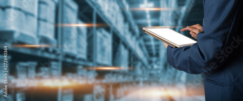 Fotomural Businessman manager using tablet check and control for workers with Modern Trade warehouse global business commerce concept or import-export commercial logistic