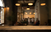 Image Of Wooden Table In Front Of Abstract Blurred Background Of Resturant Lights