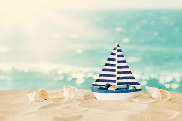 vintage wooden boat over beach sand and sea landscape background