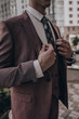 © Yevhen - Man in elegant custom tailored expensive suit posing in front of building background. Classic style