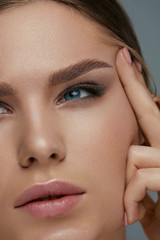 Beauty face makeup. Woman with beautiful eyes and eyebrows