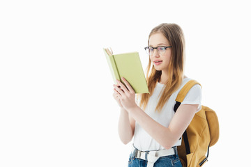Wall Mural - excited schoolgirl with backpack reading book isolated on white