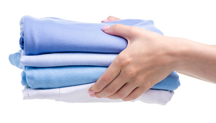 Wall Mural - Stack blue folded clothing in hand on white background isolation