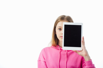 Wall Mural - teenage girl holding digital tablet with blank screen in front of face isolated on white