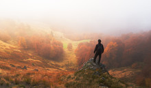 Man Stands On Background Of Autumn Landscape