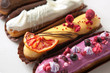 Set of several eclairs with various fillings and design isolate on a white background, the concept of French cuisine