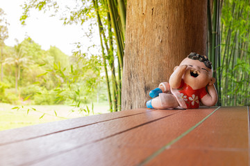 Wall Mural - smiled boy ceramic doll in reclining posture