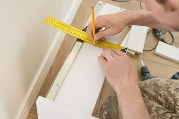 Closeup of furniture assembly with professional tools.