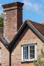 English Period House Close-up With White Sash Window And Chimney.