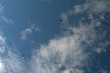 kite flying in the sky,motorized paraglider,sky, parachute, blue, sport, fly, paragliding, flying,adventure, air, cloud, freedom, 