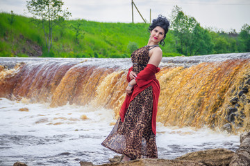 Wall Mural - Woman on the waterfalls. Little waterfall. Camping. . Young woman. Woman in a dress.