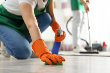 Sticker - Woman cleaning floor with sponge, closeup. Space for text