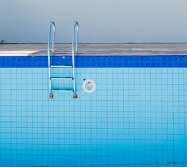 Empty dry swimming pool preparing for cleaning.