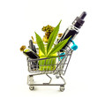 Purchasing Cannabis oil concept, Cannabis CBD oil bottles in miniature shopping cart
