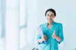 © LIGHTFIELD STUDIOS - happy latin doctor showing thumb up and smiling at camera while standing by window in hospital