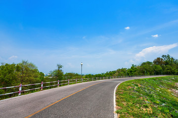 road view reservoir green tree with green nature forest in the hill and blue sky background.