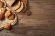 © LIGHTFIELD STUDIOS - top view of fresh bread slices on chopping board and buns on cloth on wooden table