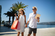 Couple On Summer Vacation Enjoying Travel And Shopping