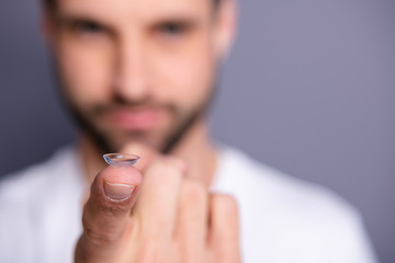 Wall Mural - Close up photo of charming lovely serious focused guy have medical service want good eye vision look perfect index finger wear white clothing isolated grey background