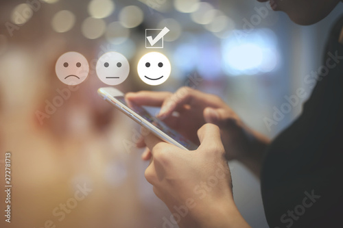 Cuadros en Lienzo Business woman use mobile pressing smiley face touch screen