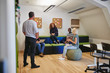 © Flamingo Images - Designers laughing during a meeting together in an office
