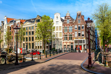 Wall Mural - Traditional dutch old houses and bridge in Amsterdam, Netherlands. Summer sunny day