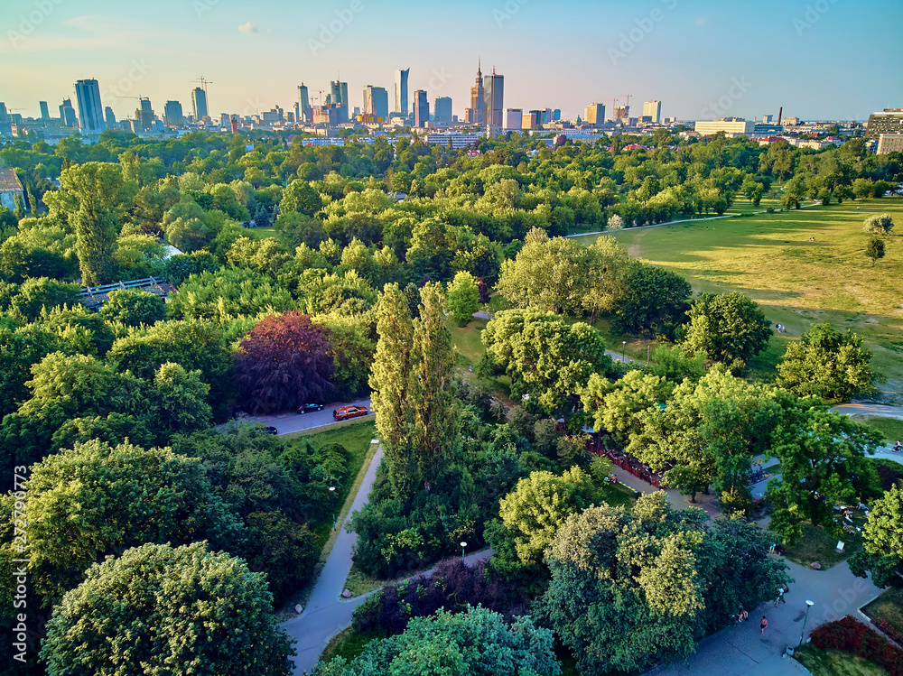 A beautiful panoramic view of the sunset in a fabulous evening in June from drone at Pola Mokotowskie in Warsaw, Poland - "Mokotow Field" is a large park in Warsaw - Is called "Jozef Pilsudski Park" - obrazy, fototapety, plakaty 