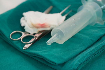 Surgical instruments on green table in operating room