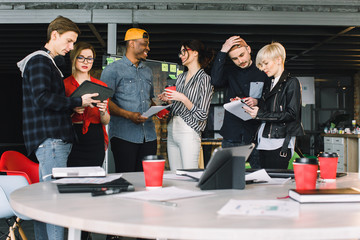 Wall Mural - Business Office Connection Contemporary Working Concept. Group of six coworkers in casual wear drinking coffee and discussing at the meeting