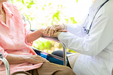Closeup Of Hand Medical Female Doctor Or Nurse Holding Senior Patient Hands And Comforting Her,.Caring Caregiver Woman Supporting Disabled Elderly People On Wheelchair,help,love,health Care Concept