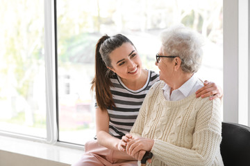 Poster - Caregiver with senior woman in nursing home