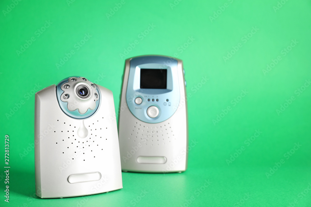 Modern baby monitor on color background