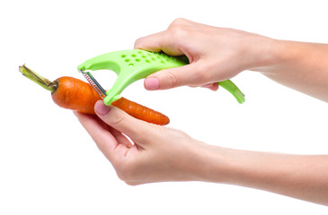 Wall Mural - Carrot vegetable peeler in hand on white background isolation