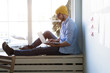 © opolja - Young businessman working on modern loft office. Man sitting by the window, using contemporary notebook.