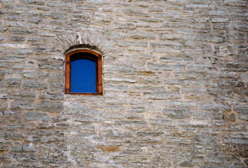 Blue window on the stone wall