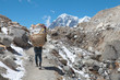 Nepal Porter carrying heavy load on his back.