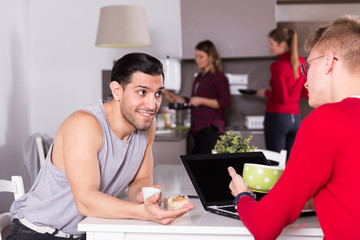 Poster - Man discussing with guy in kitchen of hostel