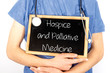 Doctor shows information on blackboard: hospice and palliative medicine.  Medical concept.