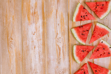 Wall Mural - Pieces of watermelon on a wooden background