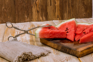 Wall Mural - Pieces of watermelon on a wooden background