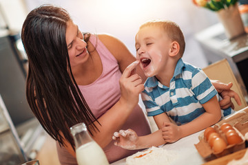 Poster - Pregnant mother and her son enjoying in kitchen