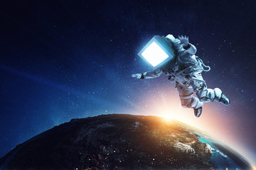 Wall Mural - astronaut with tv head in space. mixed media.