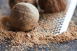 © besjunior - Making nutmeg powder process. Nuts silver grater. Kitchen still life photo. Shallow depth of field, aged brown rusty background. Selective focus.