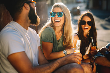 Group of young people smiling, talking and having fun together