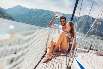 Loving couple spending happy time on a yacht at sea. Luxury vacation on a seaboat.